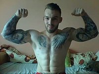 Handsome Bearded Guy with Tats Flexes His Muscles